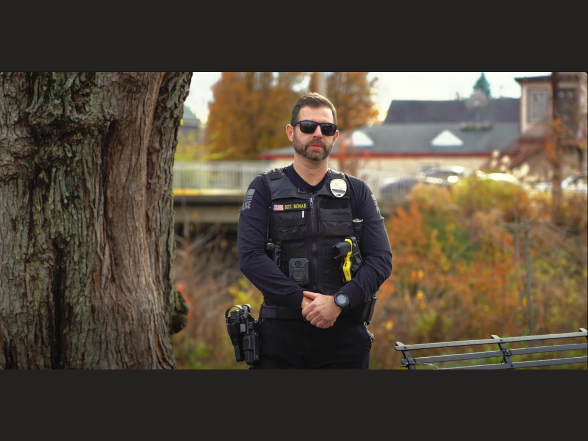 Trevor Bonar in uniform standing in front of park bench